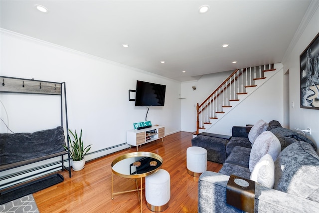 living area with crown molding, stairway, and baseboard heating