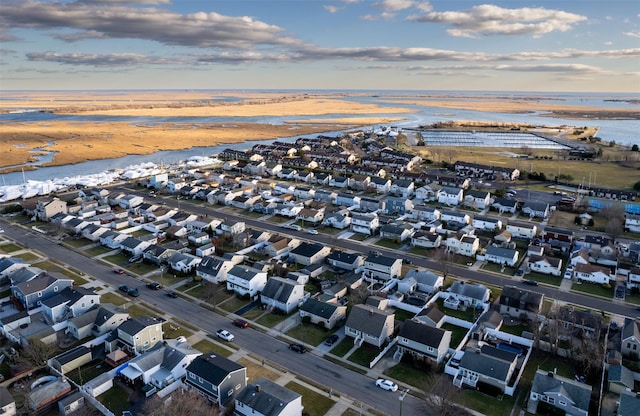 birds eye view of property featuring a view of the beach, a residential view, and a water view