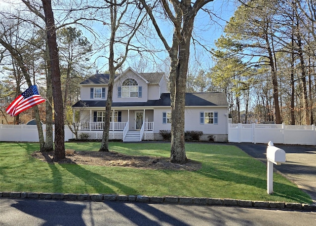 view of front of property featuring a porch, a front yard, and fence private yard