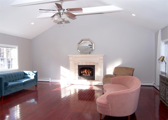 living room featuring a tile fireplace, lofted ceiling, dark wood-style flooring, baseboard heating, and recessed lighting