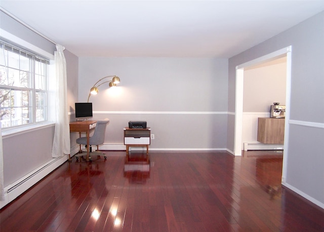 living area with a baseboard heating unit, dark wood-style flooring, a baseboard radiator, and baseboards