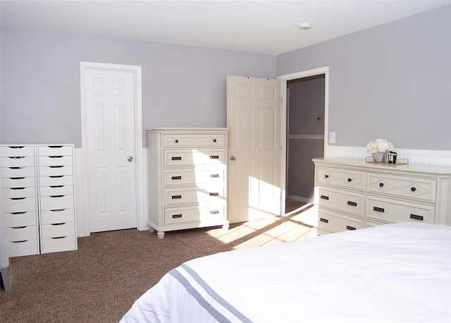 bedroom featuring dark carpet