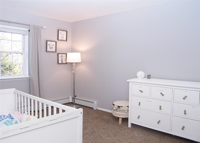 bedroom with a crib, baseboards, and dark colored carpet