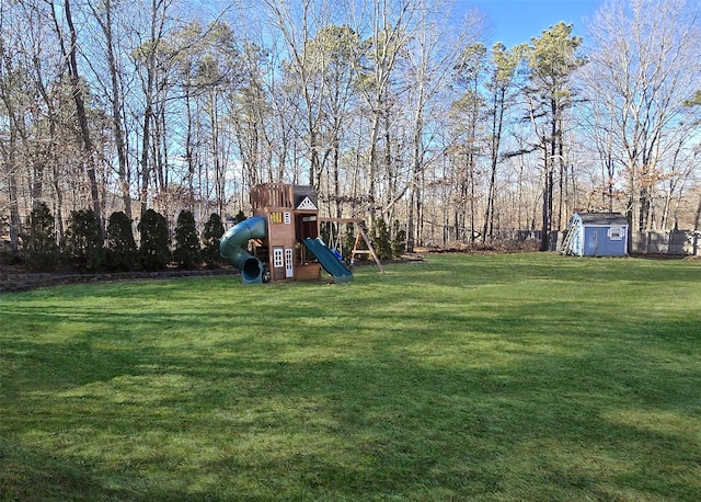 view of yard with a storage shed, playground community, and an outdoor structure