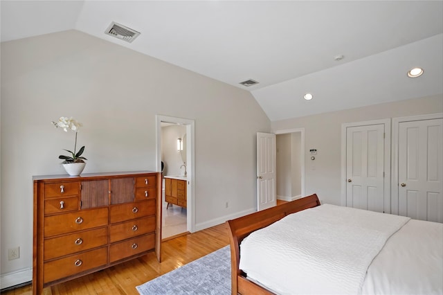 bedroom with visible vents, recessed lighting, light wood-style floors, and vaulted ceiling