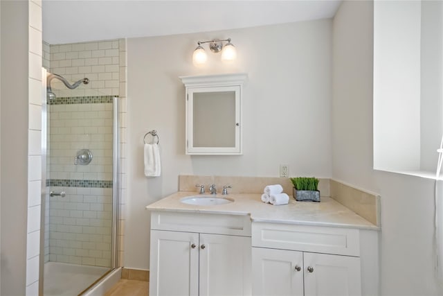 bathroom featuring vanity and a shower stall
