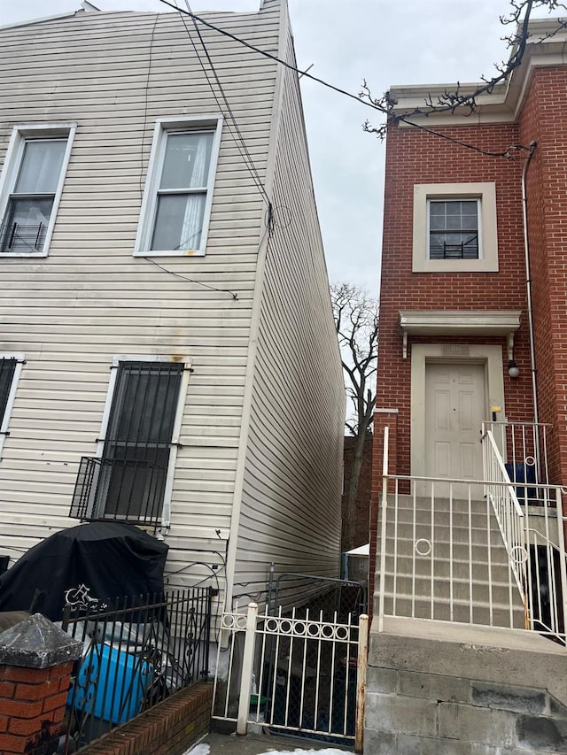 view of front facade with a fenced front yard and brick siding