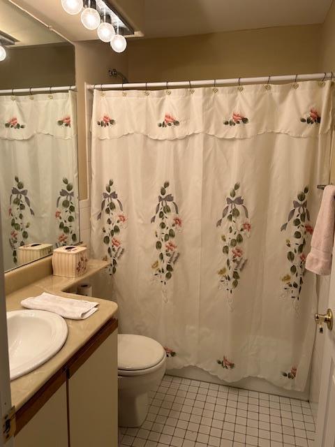 full bathroom with tile patterned flooring, vanity, and toilet