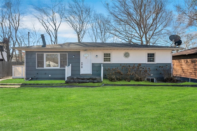 ranch-style house featuring a front yard and fence