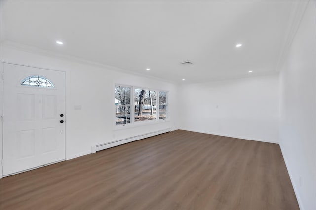 foyer entrance featuring a baseboard heating unit, wood finished floors, visible vents, baseboards, and crown molding