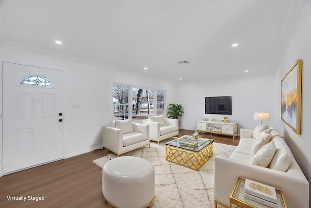 living area featuring ornamental molding, wood finished floors, visible vents, and recessed lighting