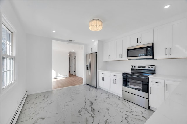 kitchen with marble finish floor, a baseboard radiator, recessed lighting, appliances with stainless steel finishes, and white cabinetry