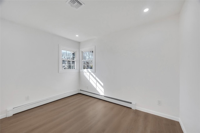 empty room featuring baseboards, visible vents, wood finished floors, and recessed lighting