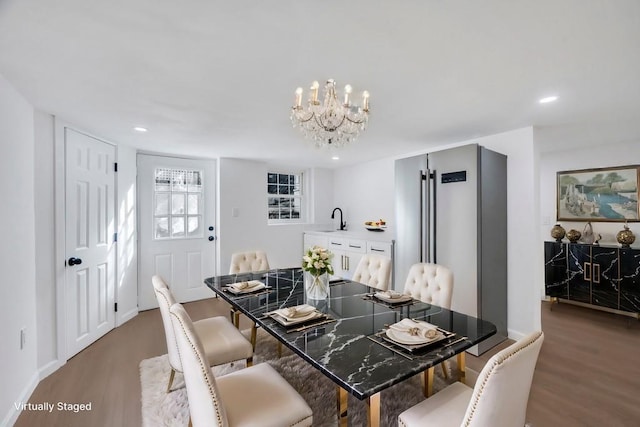 dining area with a notable chandelier, baseboards, wood finished floors, and recessed lighting