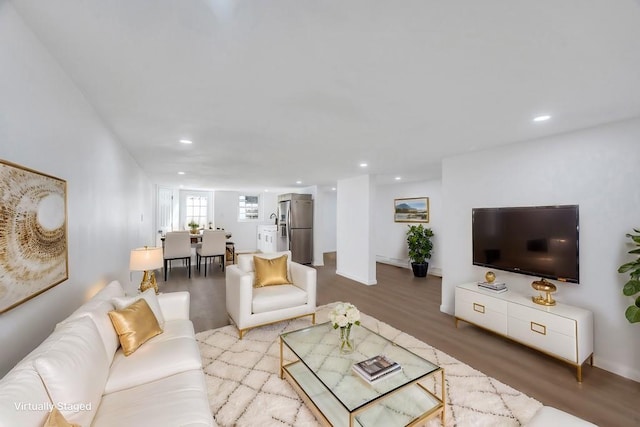 living area with wood finished floors and recessed lighting