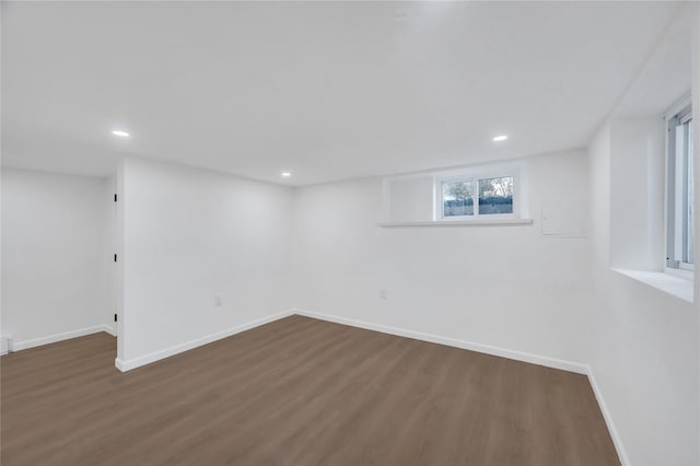 below grade area featuring recessed lighting, wood finished floors, and baseboards