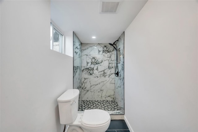 full bath featuring a marble finish shower, visible vents, baseboards, and toilet