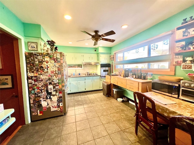 kitchen with light tile patterned floors, recessed lighting, under cabinet range hood, a ceiling fan, and appliances with stainless steel finishes