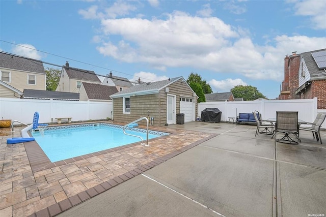 view of pool with a fenced in pool, an outbuilding, a fenced backyard, and a patio