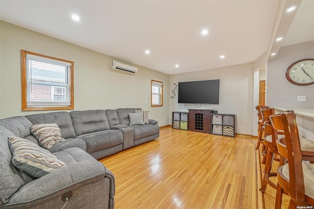 living area with recessed lighting, a wall mounted air conditioner, and wood finished floors