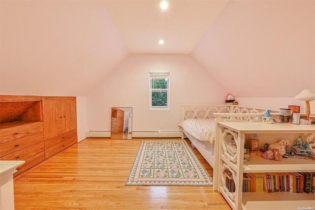 bedroom featuring lofted ceiling, baseboard heating, and wood finished floors