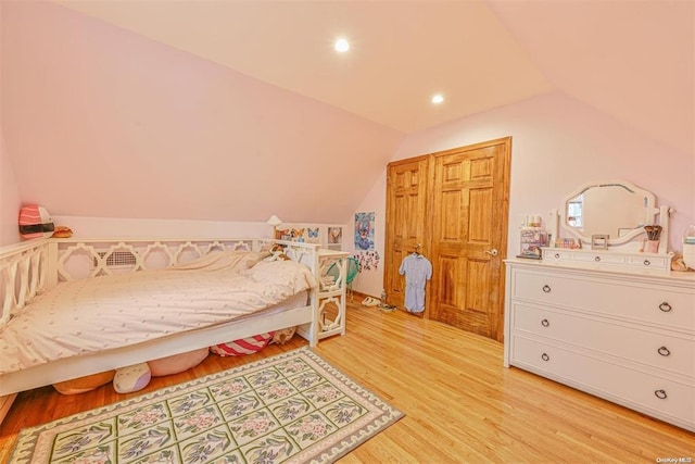 bedroom with vaulted ceiling, light wood-type flooring, and recessed lighting