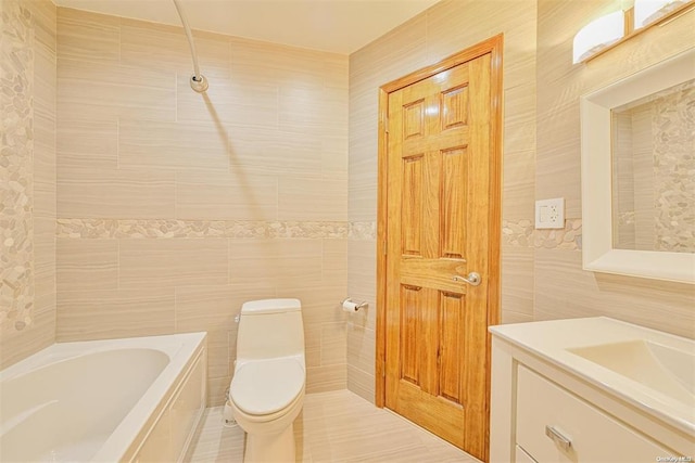 bathroom with tile walls, toilet, vanity, tile patterned flooring, and a bath