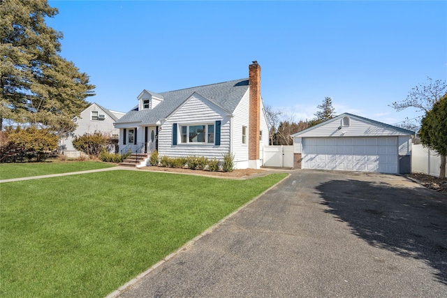 cape cod-style house featuring a chimney, fence, a garage, an outdoor structure, and a front lawn