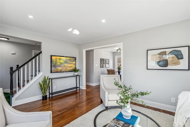 living area with stairs, recessed lighting, baseboards, and wood finished floors