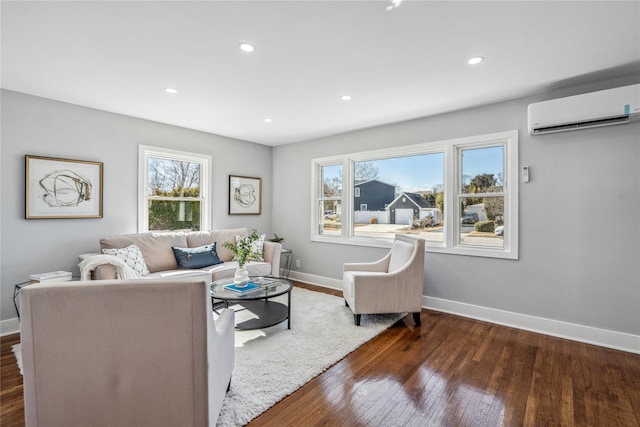 living area featuring wood-type flooring, baseboards, an AC wall unit, and recessed lighting