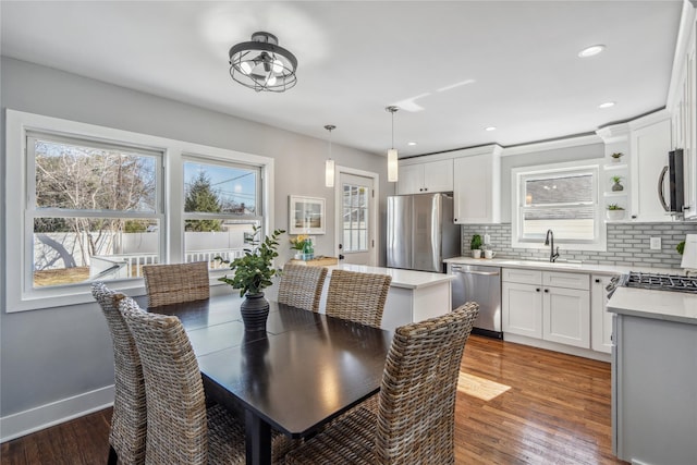 dining space featuring recessed lighting, baseboards, and wood finished floors