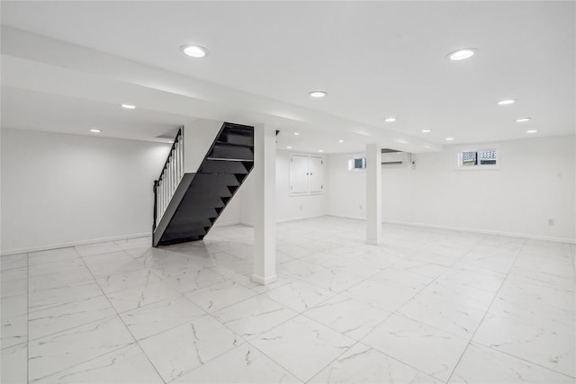 basement with recessed lighting, marble finish floor, stairway, and baseboards