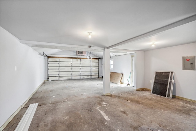 garage featuring electric panel and baseboards