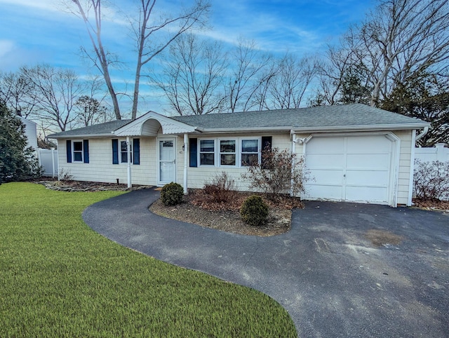 ranch-style house featuring a garage, driveway, and a front yard