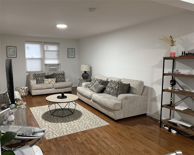 living room featuring baseboards and wood finished floors