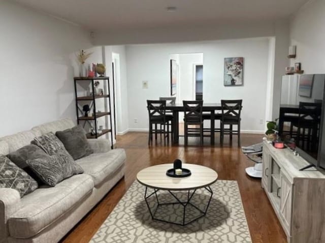 living room featuring baseboards and dark wood finished floors