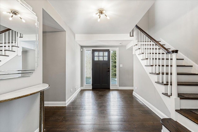 entrance foyer featuring baseboards, stairway, and hardwood / wood-style floors