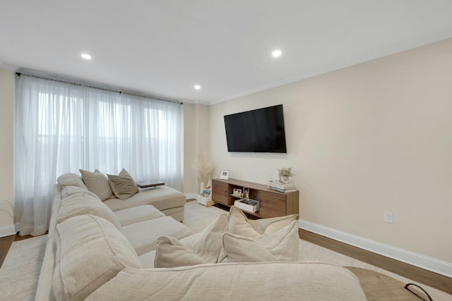 living room with ornamental molding, recessed lighting, wood finished floors, and baseboards