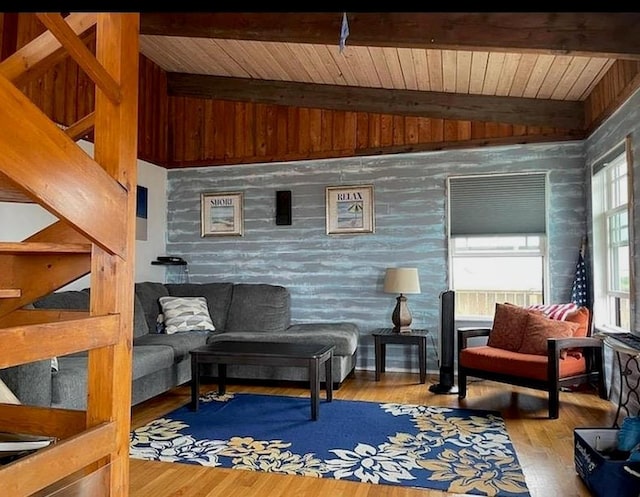 living area with wooden ceiling, vaulted ceiling with beams, and wood finished floors