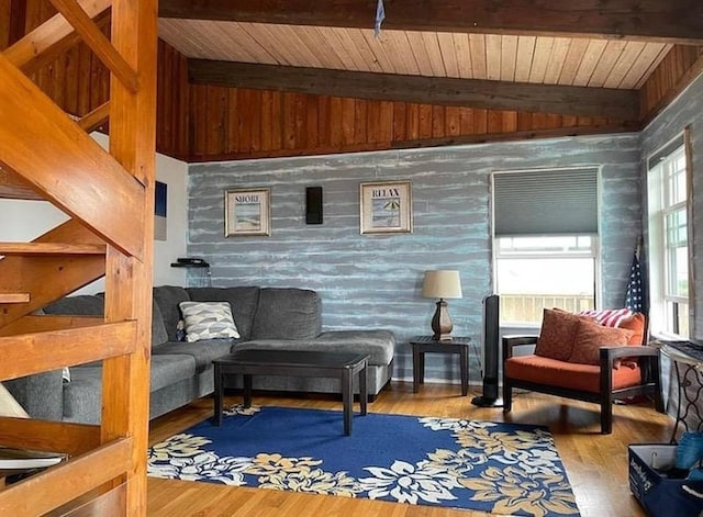 living area featuring wood finished floors, vaulted ceiling with beams, and wood ceiling