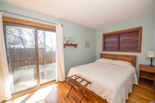 bedroom featuring wood finished floors and access to exterior