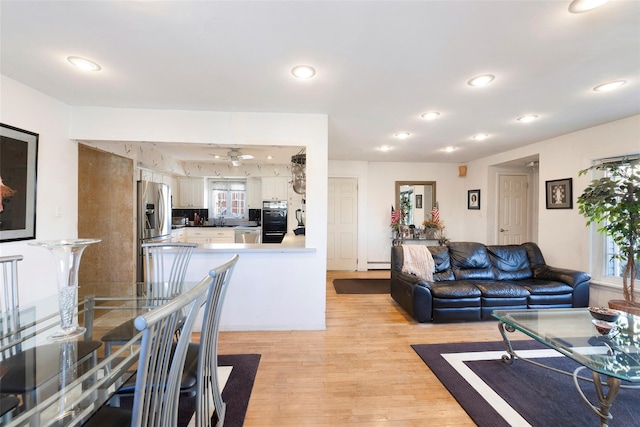 living area with ceiling fan, recessed lighting, and light wood-style floors