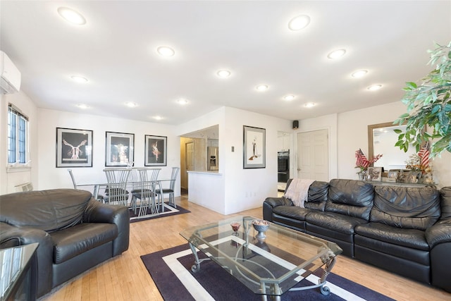 living room with light wood-style flooring and recessed lighting