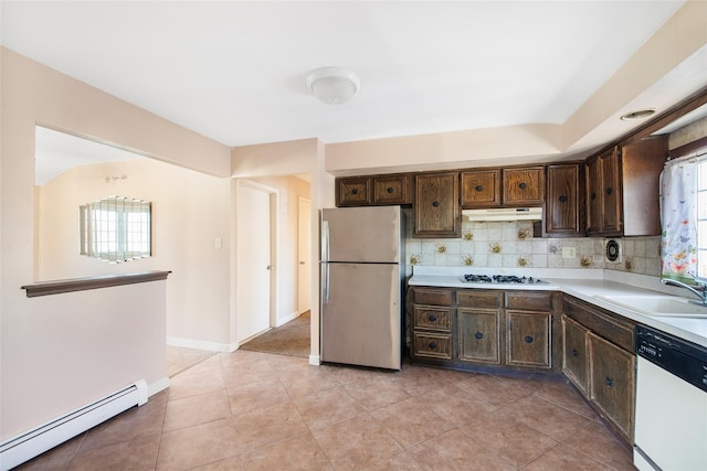 kitchen featuring a baseboard radiator, light countertops, a sink, dark brown cabinetry, and white appliances