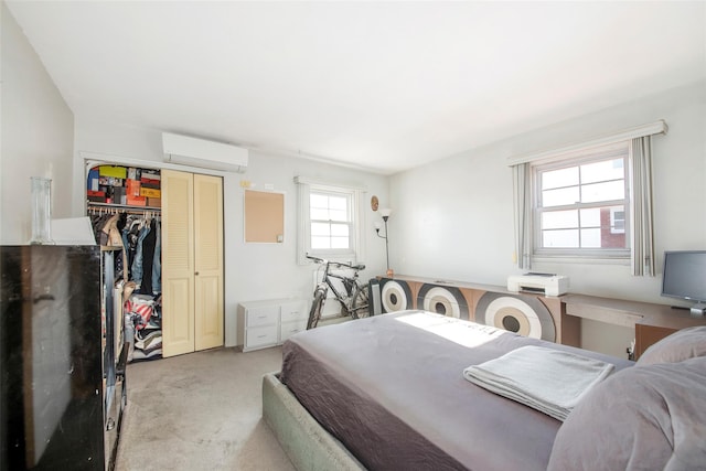 bedroom featuring light carpet, a closet, and a wall mounted air conditioner