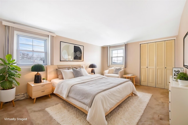 bedroom with light carpet and a closet