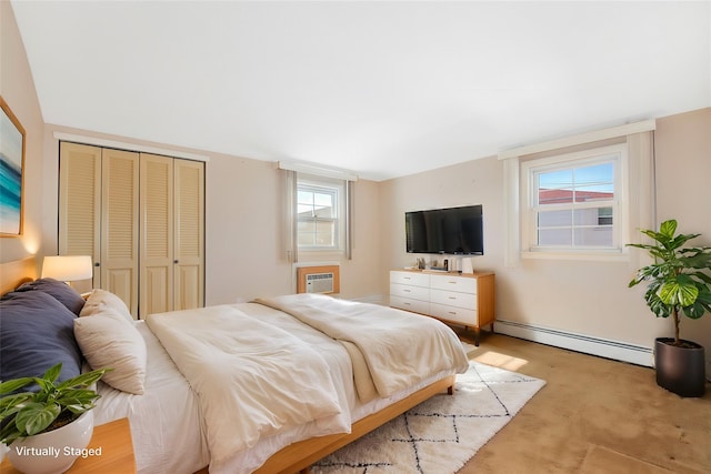 bedroom with baseboard heating, a wall unit AC, a closet, and light colored carpet