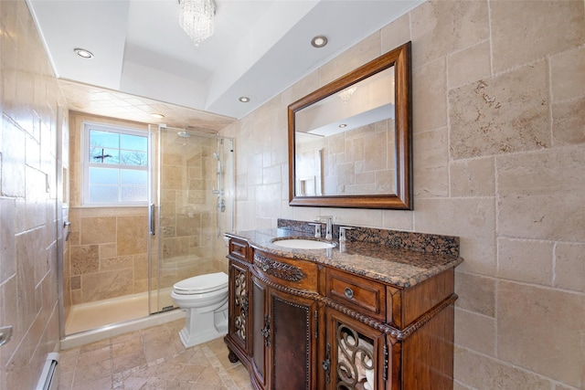 full bathroom featuring toilet, a baseboard heating unit, vanity, tile walls, and a stall shower