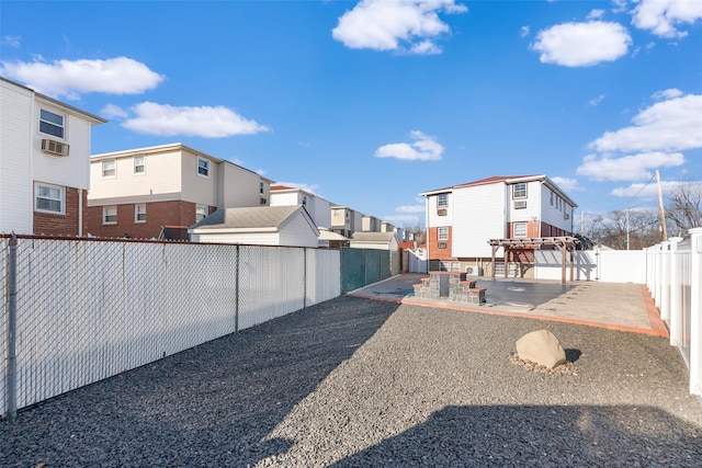 view of yard with a residential view, a fenced backyard, and a patio