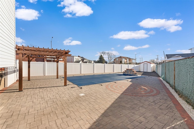 view of pool with a storage shed, a patio area, an outbuilding, and a pergola